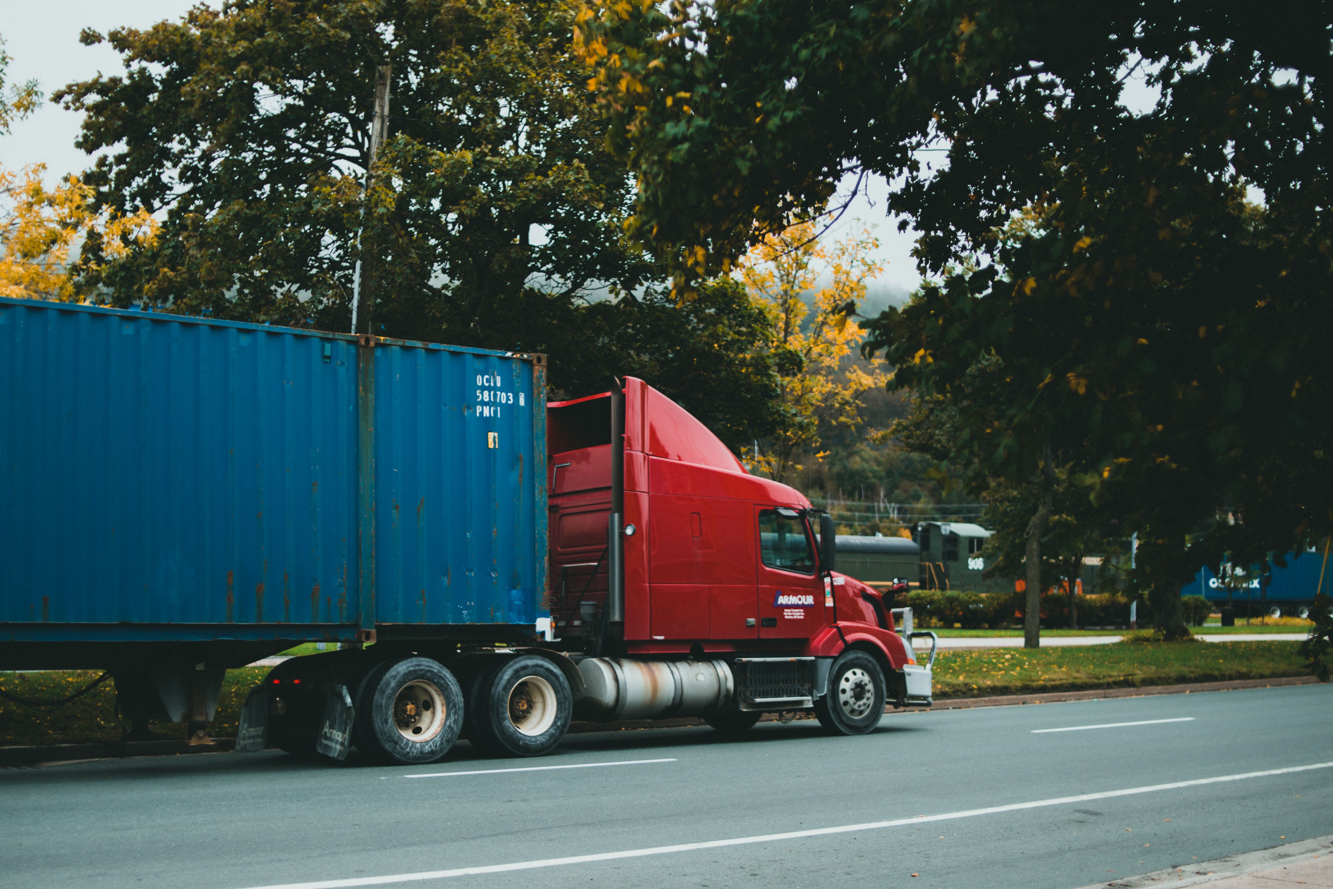 Commercial truck on highway representing Cox Logistics freight transportation services
